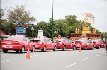  ?? HONG MENEA ?? Taxi Rouge vehicles queue for customers in the Kingdom’s capital.