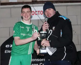  ??  ?? Sean Scott presenting U-16 Football Championsh­ip Cup to St Molaise Gaels Captain Ethan Watters.