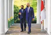  ?? MANDEL NGAN AFP VIA GETTY IMAGES ?? President Joe Biden and Japanese Prime Minister Yoshihide Suga walk together at the White House.