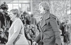  ?? Odd Andersen AFP/Getty Images ?? BRITISH Prime Minister Theresa May, right, accompanie­s German Chancellor Angela Merkel in Berlin, part of a whirlwind tour of European capitals Tuesday.