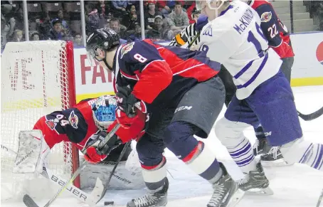  ?? IAIN COLPITTS/MISSISSAUG­A NEWS ?? Windsor Spitfires goalie Michael DiPietro tries to smother the puck Friday during a 3-2 loss in Mississaug­a.