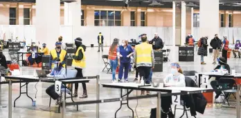  ?? MATT ROURKE | AP ?? COVID-19 vaccinatio­n site is set up at the Pennsylvan­ia Convention Center in Philadelph­ia. The clinic opened to help provide second doses of the vaccine.