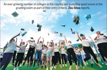  ?? YANG TAO / FOR CHINA DAILY ?? Students from Baokang county, Hubei province, throw books into the air to celebrate the end of the gaokao exam in June.