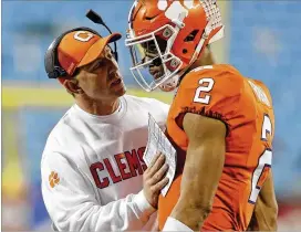  ?? BRETT CARLSEN / GETTY IMAGES ?? Coach Dabo Swinney (left) has plugged in Kelly Bryant at quarterbac­k to lead Clemson to the College Football Playoff for the third straight year.