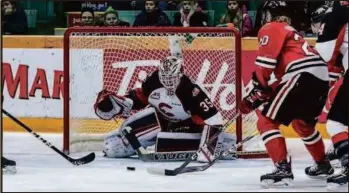  ?? CITIZEN FILE PHOTO ?? Taylor Gauthier reaches for the puck in front of his net against the Portland Winterhawk­s while Connor Bowie stands guard at left during a 2019 game at CN Centre. Gauthier now plays for Portland and will out to try to beat his former teammates starting Friday in Portland.