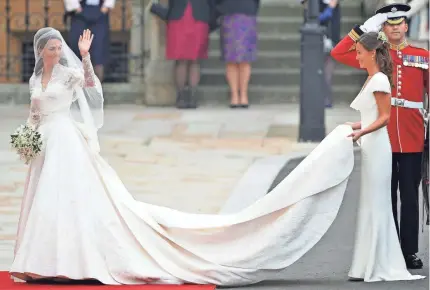  ?? PASCAL LE SEGRETAIN ?? Kate Middleton, with sister Pippa, wore Alexander McQueen when she married Prince William in 2011.