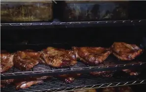  ?? The Sentinel-Record/Lance Porter ?? ■ Multiple racks of ribs are shown in an oven at Smokin’ In Style.