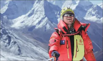  ?? PHOTOS PROVIDED TO CHINA DAILY ?? Top: Zhang Hong (third from right) and his team navigate Khumbu icefall during training in Nepal in April.
Above: Zhang is the first visually impaired person from Asia to conquer the summit of Qomolangma. Right: Zhang(left) and his team share a meal on Lobuche in Nepal in April to prepare for the climbing of Qomolangma.