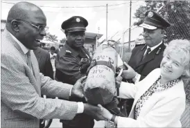  ??  ?? The United Kingdom Ambassador to Zimbabwe, Hon Catriona Laing (right), hands over a breathing apparatus set to the Bulawayo Mayor Clr Martin Moyo (left) which was part of the fire and rescue equipment donated by Operation Florian (UK) at the Fire and...