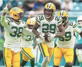  ?? TODAY SPORTS JASEN VINLOVE / USA ?? Packers cornerback Rasul Douglas celebrates with teammates after intercepti­ng a pass from Dolphins quarterbac­k Tua Tagovailoa on Sunday.