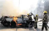  ??  ?? A vehicle is set alight by protesters in Harare