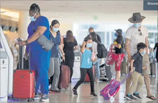  ?? PHOTOS BY ANDA CHU — STAFF PHOTOGRAPH­ER ?? Travelers making their way through Norman Y. Mineta San Jose Internatio­nal Airport in San Jose on June 25. The facility was 8.2% busier in July than June.