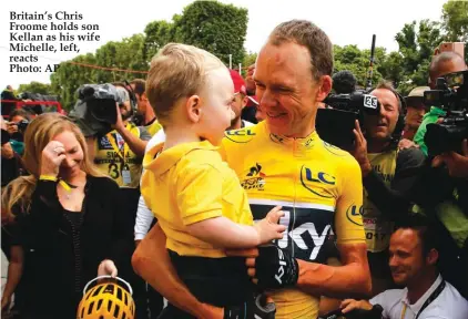  ??  ?? Britain’s Chris Froome holds son Kellan as his wife Michelle, left, reacts Photo: AP