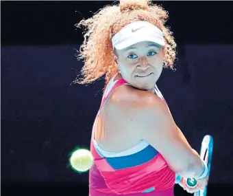  ?? BRANDON MALONE AFP VIA GETTY IMAGES ?? Japan’s Naomi Osaka hits a return against Colombia’s Camila Osorio during their first-round singles match at the Australian Open in Melbourne on Monday. Osaka finished with a 6-3, 6-3 win over Osorio.