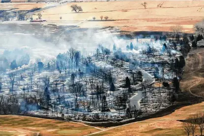  ?? Hart Van Denburg / Associated Press ?? A Boulder County neighborho­od smolders Friday after it was was destroyed by a wildfire. Authoritie­s reported more than 500 homes have been destroyed after tens of thousands of Coloradans were forced to evacuate.