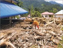  ?? Mavendra JR Associated Press ?? A FLASH FLOOD in March swept logs into Pesisir Selatan, West Sumatra. Environmen­talists say Indonesia’s deforestat­ion is partly to blame for such disasters.