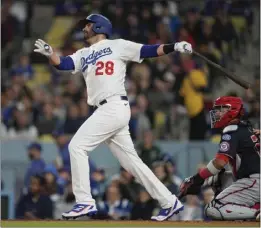  ?? ASHLEY LANDIS – THE ASSOCIATED PRESS ?? Dodgers designated hitter J.D. Martinez hits a two-run homer during the seventh inning of Tuesday night's game against the Washington Nationals at Dodger Stadium.