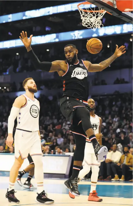  ?? Photos by Streeter Lecka / Getty Images ?? LeBron James dunks in front of Team Giannis’ Blake Griffin in the first quarter of the All-Star Game. James, the captain of his team, had 17 points and eight rebounds for a squad that rallied from a 20-point, third-quarter deficit for the victory.