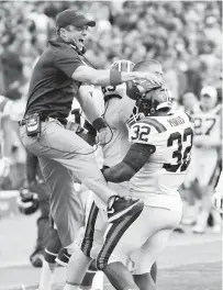  ?? PRESS FILE
STEVE HELBER/ASSOCIATED ?? As a Virginia Tech assistant coach in 2015, Shane Beamer celebrates with fullback Steven Peoples after a good play during a victory against Virginia. Beamer is South Carolina’s new head coach.