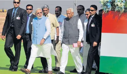  ?? EPA ?? Indian prime minister Narendra Modi walks during ‘Aero India-2015’ at Yelahanka air base in Bangalore, India, yesterday. The 10th edition of the event runs until Sunday. It showcases military aircraft from leading manufactur­ers across the globe.