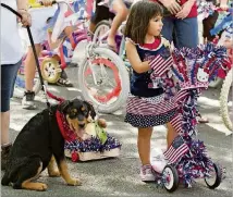  ?? AMERICAN STATESMAN 2012 ?? Madelyn Padilla-Harris, 4, waits to ride her decorated scooter in the 2012 Georgetown Fourth of July Hometown Parade.