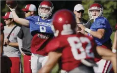  ?? PHOTO/SUE OGROCKI ?? In this Aug. 17, file photo, Oklahoma quarterbac­ks Tanner Schafer (left) and Austin Kendall (right) throw during NCAA college football practice in Norman, Okla. Oklahoma will start figuring out who will replace Heisman Trophy-winning quarterbac­k Baker...