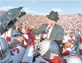  ??  ?? Earle Bruce is carried off the field after winning his last game as Ohio State coach, beating Michigan in 1987 a few days after being fired.