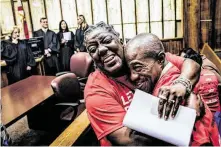  ?? Scott McIntyre / New York Times ?? Carmen Brown embraces Leonel Frage at a special court hearing Friday in Miami, where former felons cleared an important hurdle preventing them from regaining the right to vote.