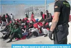  ??  ?? ALGECIRAS: Migrants rescued at sea wait to be transferre­d at the harbor of Algeciras. —AFP