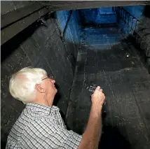  ??  ?? Historian Kerry Neal at the bottom of the escape hatch in an undergroun­d World War II bunker on private property in Stoke in Nelson.