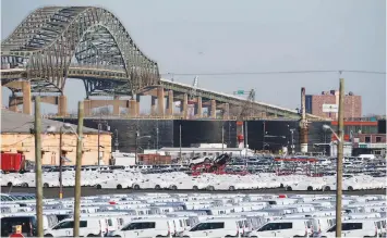  ?? — Reuters ?? Vehicles are seen parked in a lot at the port of Newark New Jersey, US.