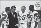  ?? THE ASSOCIATED PRESS ?? Former Philadelph­ia Eagles players now with the Los Angeles Rams pose with head coach George Allen prior to their game with Baltimore on Sunday, Nov. 27, 1966 in Baltimore. From left, they are Tommy McDonald, Maxie Baughn and Irv Cross.