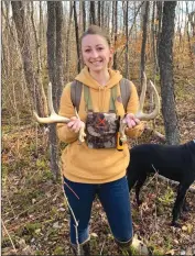  ?? Photo by Bethany Ford ?? Ford holds a set of whitetail sheds in the woods. It’s always a perk when you get the matching set.