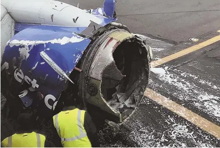  ?? AP PHOTO ?? ‘MANDATORY ACTION’: The engine on a Southwest Airlines plane is inspected as it sits on the runway at the Philadelph­ia Internatio­nal Airport after it made an emergency landing in Philadelph­ia on Tuesday. The FAA has now ordered ultrasound inspection­s...