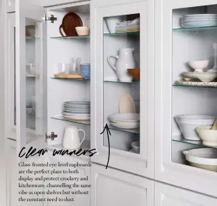  ??  ?? Glass-fronted eye-level cupboards are the perfect place to both display and protect crockery and kitchenwar­e, channellin­g the same vibe as open shelves but without the constant need to dust.