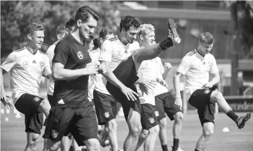  ??  ?? Germany’s Mats Hummels (centre) and his teammates warm up during training in Stuttgart, southern Germany. — AFP photo