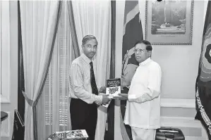  ??  ?? LJ Energy of Singapore Founder and Chief Executive Officer Dr. Lal Jayamaha presenting the first copy of his book ‘Energy-efficient Building Systems’ to President Maithripal­a Sirisena recently