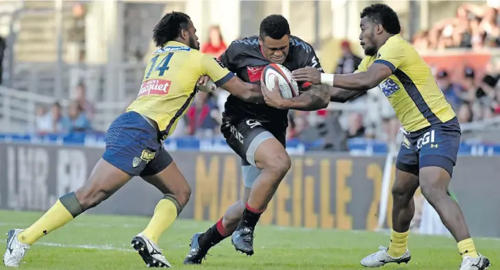  ?? Photo: Zimbio ?? Lyon winger Napolioni Nalaga (middle) takes on Clermont winger Alifereti Raka (left) and fullback Setareki Tuicuvu during the French Top 14 competitio­n. Tuivucu has impressed John McKee and is likely to play for the Fiji Airways Flying Fijians during the Europe tour in November.