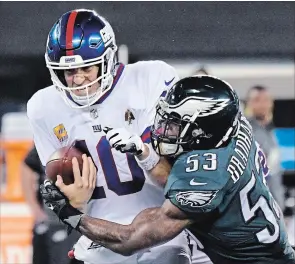  ?? ASSOCIATED PRESS FILE PHOTO ?? New York Giants quarterbac­k Eli Manning, sacked here by Philadelph­ia Eagles’ Nigel Bradham on Oct. 11, has been sacked 20 times this season, third most in the National Football League.