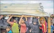  ?? AP ?? Rohingya Muslims wait in a queue to receive aid.