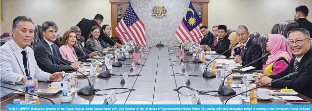  ?? —AFP ?? KUALA LUMPUR: Malaysia’s Speaker of the Dewan Rakyat, Azhar Azizan Harun (4R), and Speaker of the US House of Representa­tives Nancy Pelosi (3L) posing with their delegation before a meeting at the Parliament House in Kuala Lumpur.