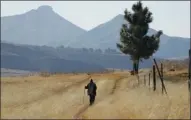  ?? The Associated Press ?? A man walks near Ha Mampho village in Lesotho.