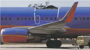  ?? ASSOCIATED PRESS FILE PHOTO ?? Twice in the last nine years, the roofs have peeled off Southwest planes during flight, including this plane seen in Yuma, Ariz., in 2011.