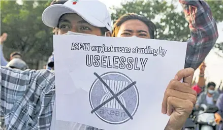  ?? REUTERS ?? An anti-coup protester holds a placard criticisin­g the Associatio­n of Southeast Asian Nations, in Mandalay, Myanmar, on June 5.