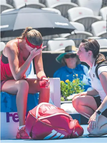  ?? Picture: AAP ?? OUT: Kristina Mladenovic, of France (left), retires from the match against Ellen Perez.