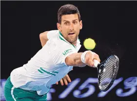  ?? ANDY BROWNBILL/ASSOCIATED PRESS ?? Novak Djokovic, shown hitting a backhand to Aslan Karatsev in the semifinals, is one win from his 18th career Slam title, which would be two off the record.