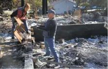  ?? Paul Chinn / The Chronicle ?? Matthew and Coby Stockton are still clearing the rubble of their Santa Rosa home, which was destroyed in the Tubbs Fire.