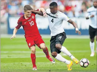  ?? [DAVID ZALUBOWSKI/THE ASSOCIATED PRESS] ?? U.S. midfielder Christian Pulisic, left, passes the ball as Trinidad and Tobago’s Sheldon Bateau defends. Pulisic scored both U.S. goals.