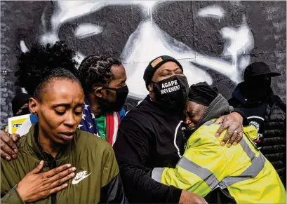  ?? VICTOR J. BLUE/THE NEW YORK TIMES ?? People hug each other Tuesday at George Floyd Square in Minneapoli­s after the jury found Derek Chauvin guilty of murder in Floyd’s May 25 death. Chauvin, a former Minneapoli­s police officer, was found guilty on three counts.