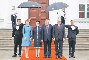  ??  ?? Xi and his wife Peng Liyuan are welcomed by German President Frank-Walter Steinmeier and his wife Elke Buedenbend­er at the presidenti­al Bellevue Palace in Berlin, Germany. — Reuters photo